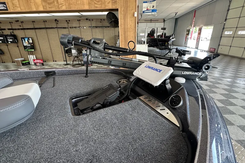 Slide: The Image of 2024 Triton 18 TrX boat interior with Lowrance electronics and trolling motor in showroom. - 8