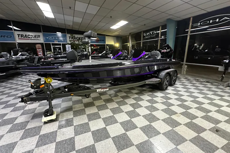 Slide: The Image of 2025 Triton 19 TrX Patriot boat displayed in showroom with checkered floor. - 59
