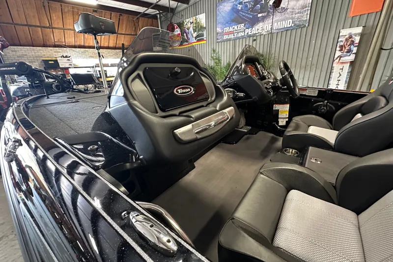 Slide: The Image of 2025 Triton 19 TrX Patriot boat interior with sleek seating and modern dashboard. - 12
