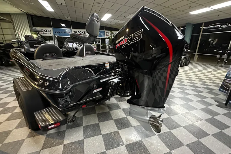 Slide: The Image of 2025 Triton 19 TrX Patriot boat with Mercury Pro XS engine in showroom. - 64