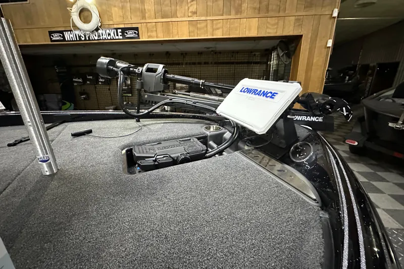 Slide: The Image of 2025 Triton 19 TrX Patriot boat with Lowrance electronics and trolling motor in a showroom. - 74