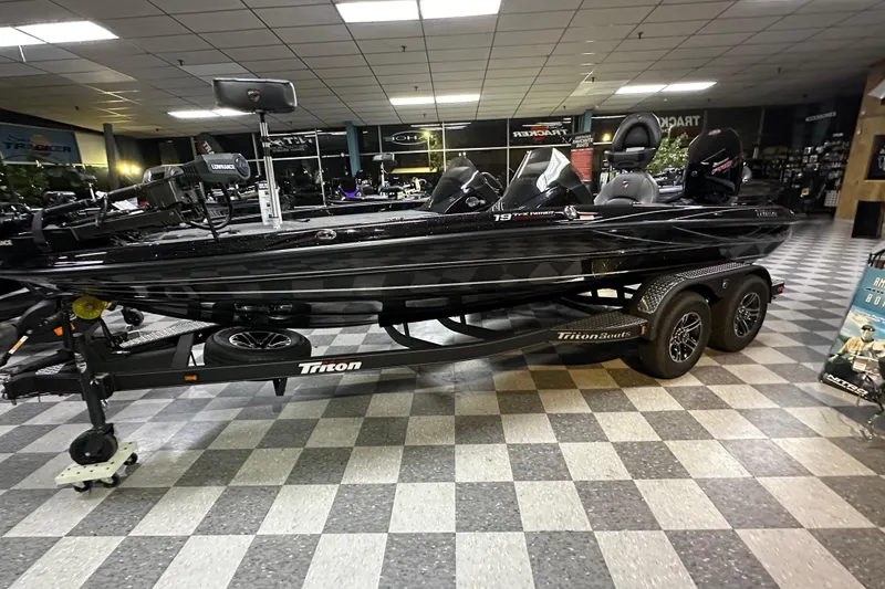Slide: The Image of 2025 Triton 19 TrX Patriot boat displayed indoors on a checkered floor. - 65