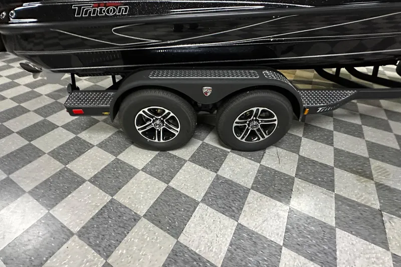 Slide: The Image of 2025 Triton 19 TrX Patriot boat trailer on checkered floor. - 71