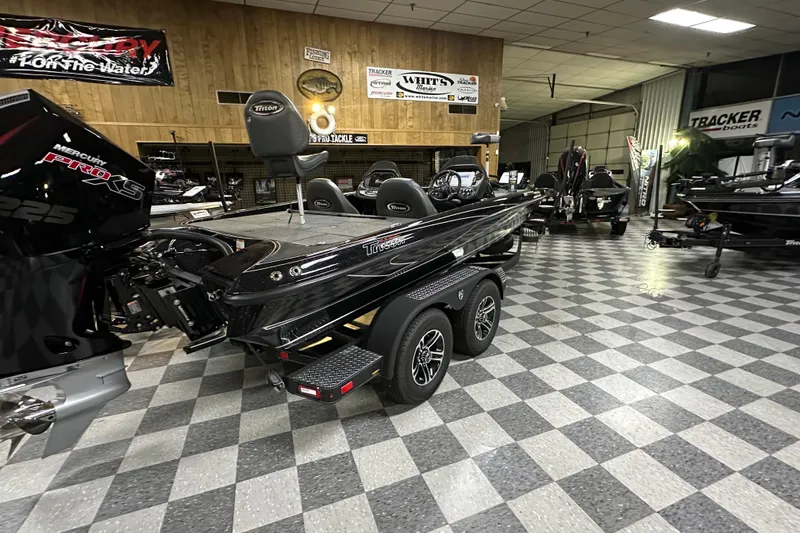 Slide: The Image of 2025 Triton 19 TrX Patriot boat in showroom, featuring Mercury Pro XS engine. - 61