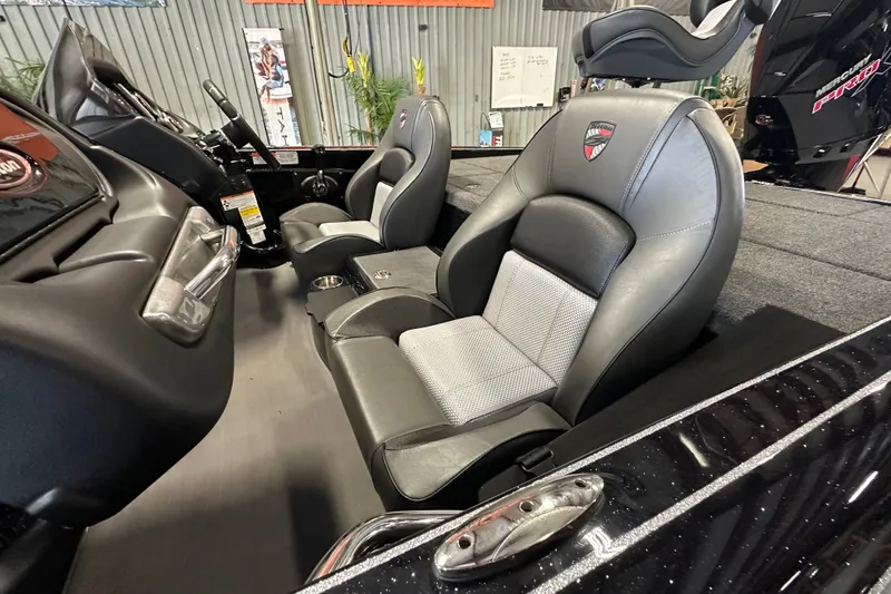 Slide: The Image of 2025 Triton 19 TrX Patriot boat interior with sleek black and gray seating. - 11