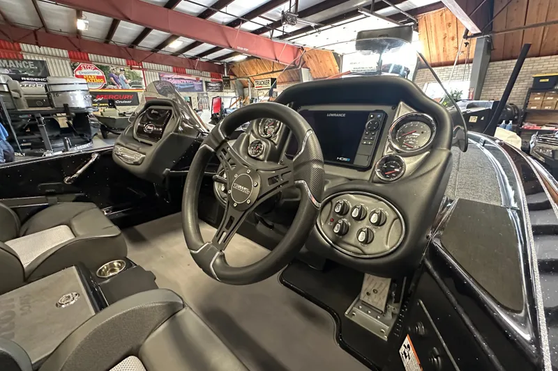 Slide: The Image of Interior view of 2025 Triton 19 TrX Patriot boat with steering wheel and dashboard controls. - 14