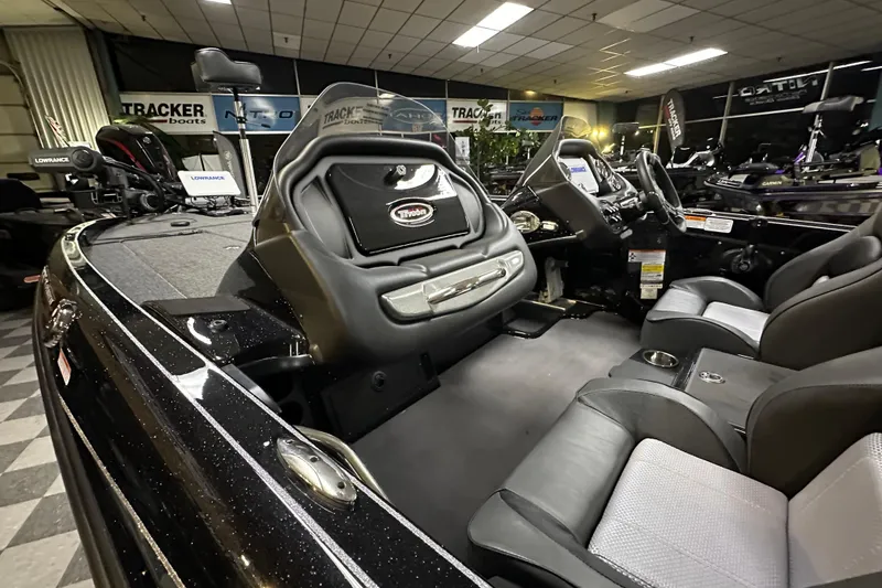 Slide: The Image of Interior of a 2025 Triton 19 TrX Patriot boat, showcasing seating and dashboard features. - 69