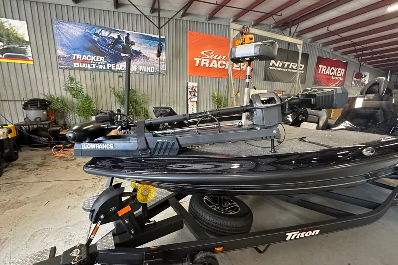 Slide: The Image of 2025 Triton 19 TrX Patriot boat in showroom with Lowrance equipment. - 9