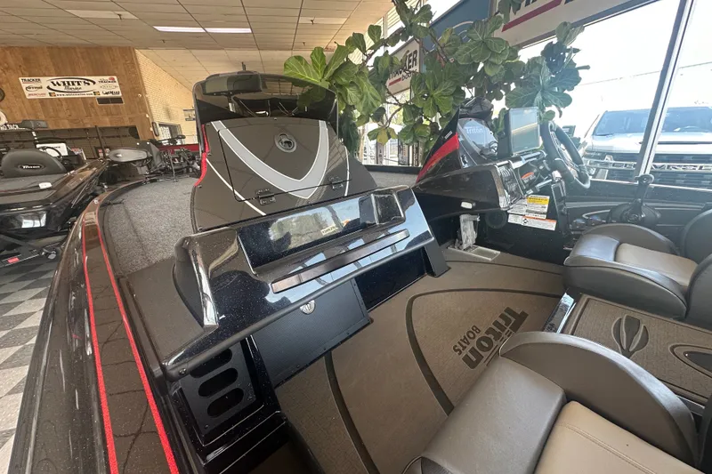 Slide: The Image of 2026 Triton 20XP Patriot boat interior with modern dashboard and seating in showroom. - 132