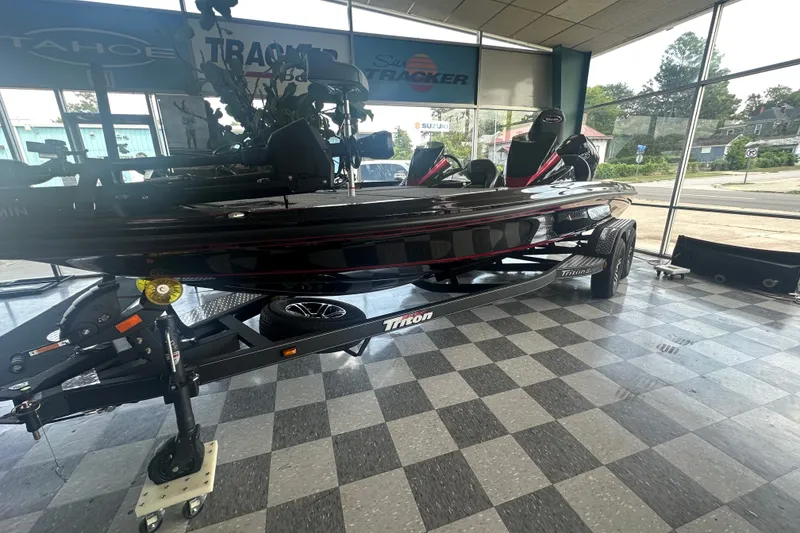 Slide: The Image of 2026 Triton 20XP Patriot boat displayed in showroom with checkered floor. - 139