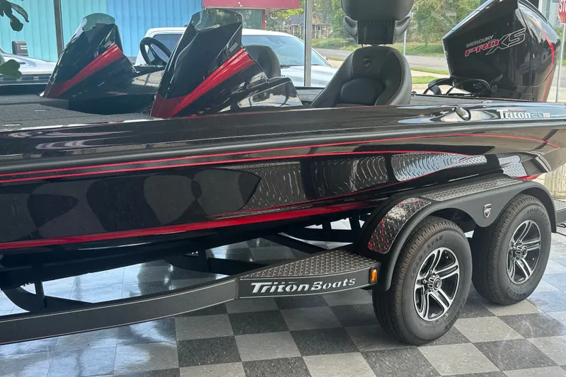 Slide: The Image of 2026 Triton 20XP Patriot boat with sleek black and red design on display. - 128