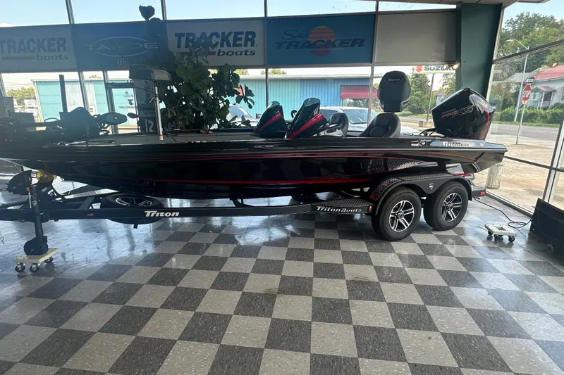 Slide: The Image of 2026 Triton 20XP Patriot boat displayed in showroom with checkered floor. - 126