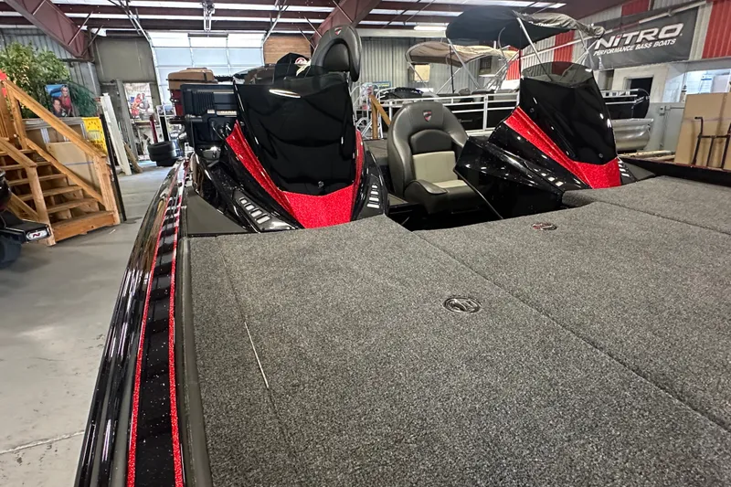 Slide: The Image of 2026 Triton 20XP Patriot boat in showroom, featuring sleek design and red accents. - 9