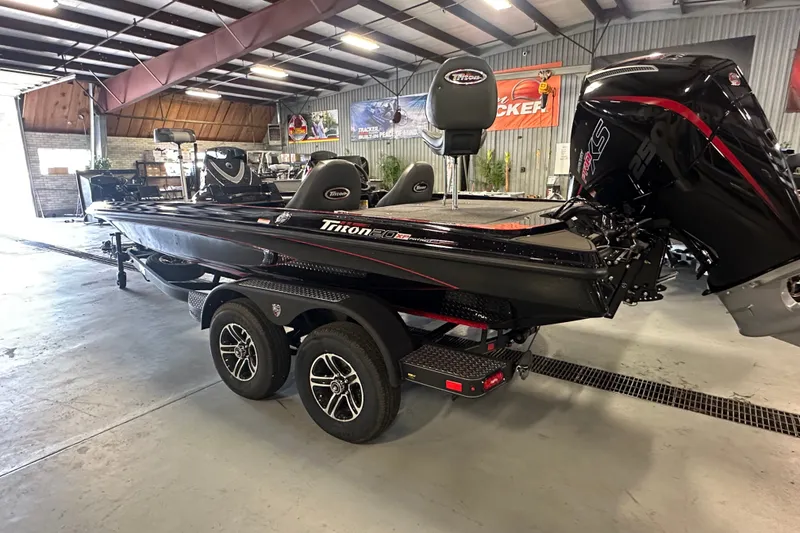 Slide: The Image of 2026 Triton 20XP Patriot boat in showroom, featuring sleek design and powerful engine. - 4