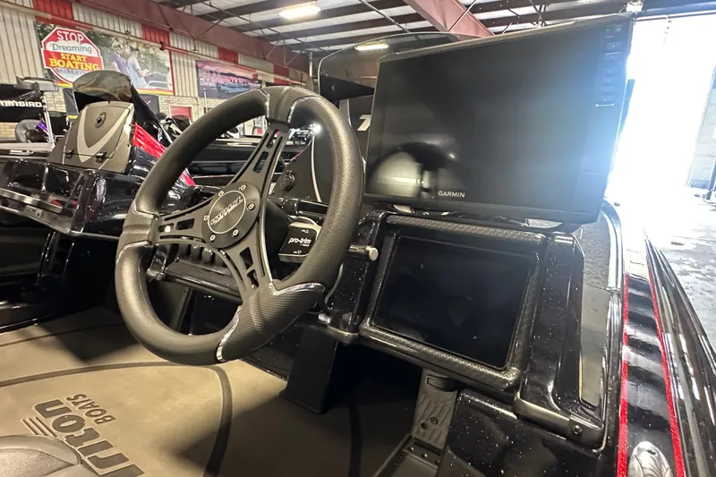 Slide: The Image of Interior of 2026 Triton 20XP Patriot boat with steering wheel and Garmin display. - 6