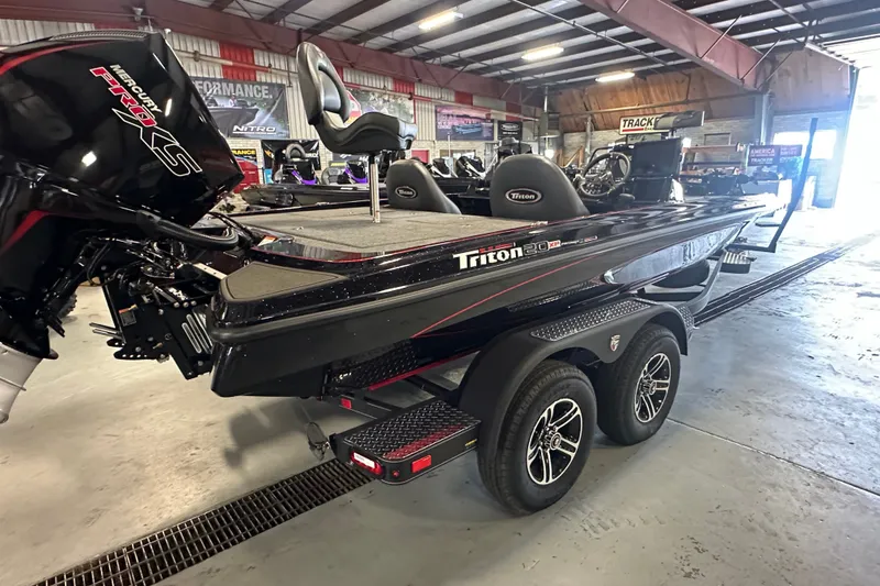 Slide: The Image of 2026 Triton 20XP Patriot boat with Mercury Pro XS engine in a showroom. - 5