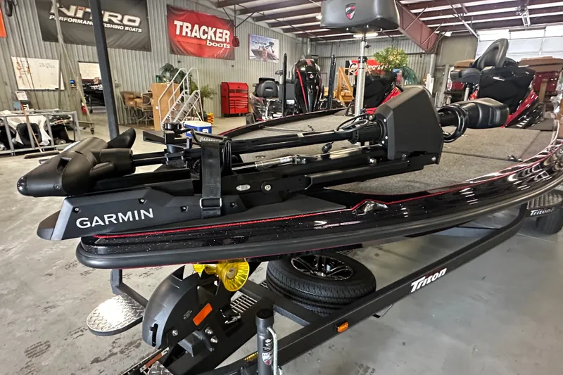 Slide: The Image of 2026 Triton 20XP Patriot boat with Garmin equipment in a showroom. - 11