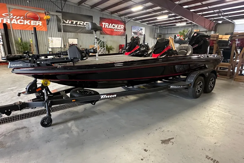 Slide: The Image of 2026 Triton 20XP Patriot boat in showroom, featuring Garmin equipment and dual-axle trailer. - 3