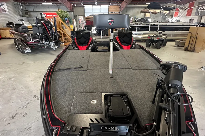 Slide: The Image of 2026 Triton 20XP Patriot boat in showroom, featuring Garmin equipment and spacious deck. - 19