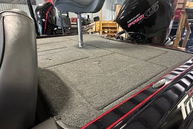 Slide: The Image of 2026 Triton 20XP Patriot boat deck with Mercury Pro XS engine in a garage setting. - 15