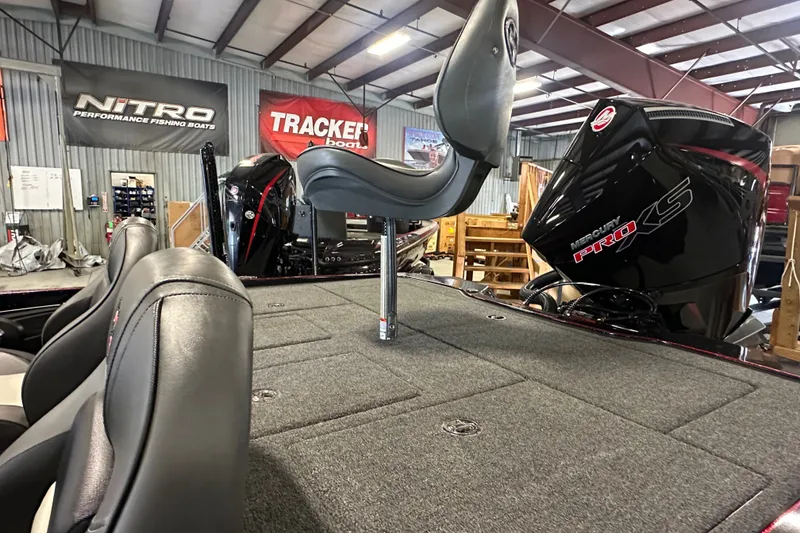 Slide: The Image of 2026 Triton 20XP Patriot boat interior with Mercury Pro XS engine in showroom. - 16