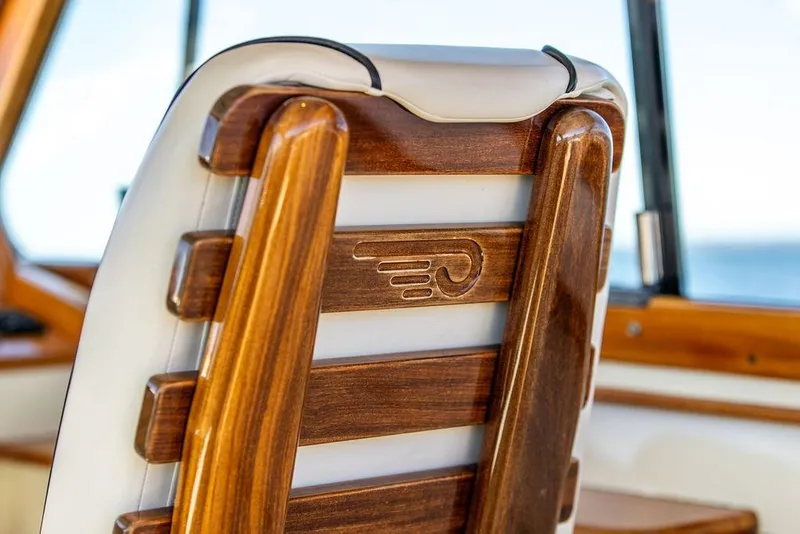 Slide: The Image of Wooden seat detail on 2014 Hinckley Talaria 34 boat, showcasing craftsmanship and luxury design. - 10