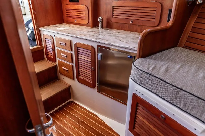 Slide: The Image of Interior of 2014 Hinckley Talaria 34 yacht with wooden cabinetry and seating. - 12