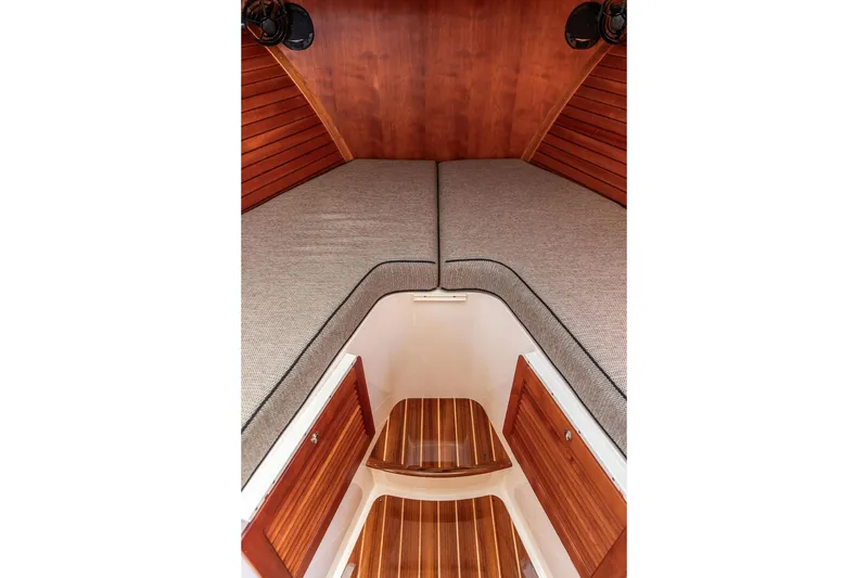 Slide: The Image of Interior cabin of 2014 Hinckley Talaria 34 with wooden accents and cushioned seating. - 13