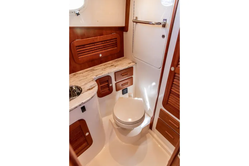 Slide: The Image of Luxurious 2014 Hinckley Talaria 34 yacht bathroom with wood accents and modern fixtures. - 15