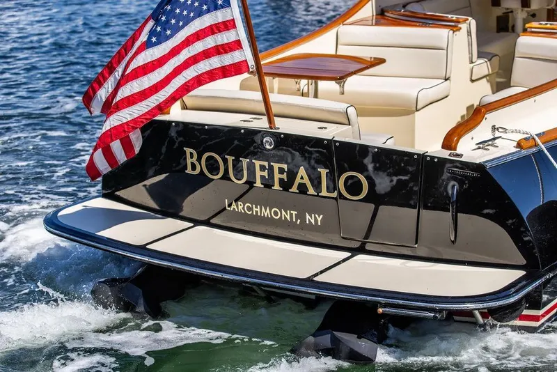 Slide: The Image of 2014 Hinckley Talaria 34 boat with American flag, named "Bouffalo," in Larchmont, NY waters. - 17