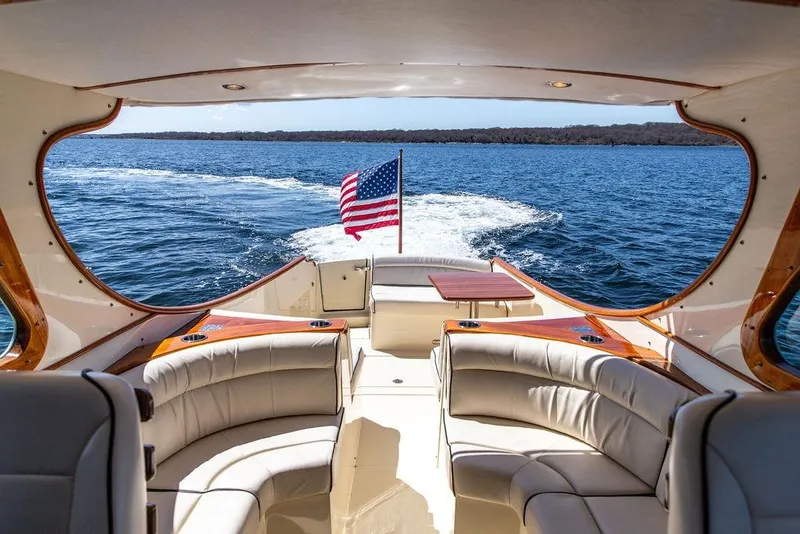 Slide: The Image of Luxurious 2014 Hinckley Talaria 34 yacht interior with American flag on open water. - 9