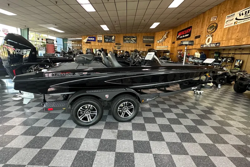 The Image of 2026 Triton 20XP Patriot boat displayed in showroom with checkered flooring. - 0
