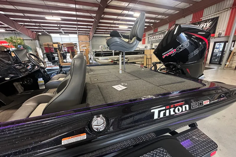 Slide: The Image of 2026 Triton 20XP Patriot boat with Mercury Pro XS engine in showroom. - 18