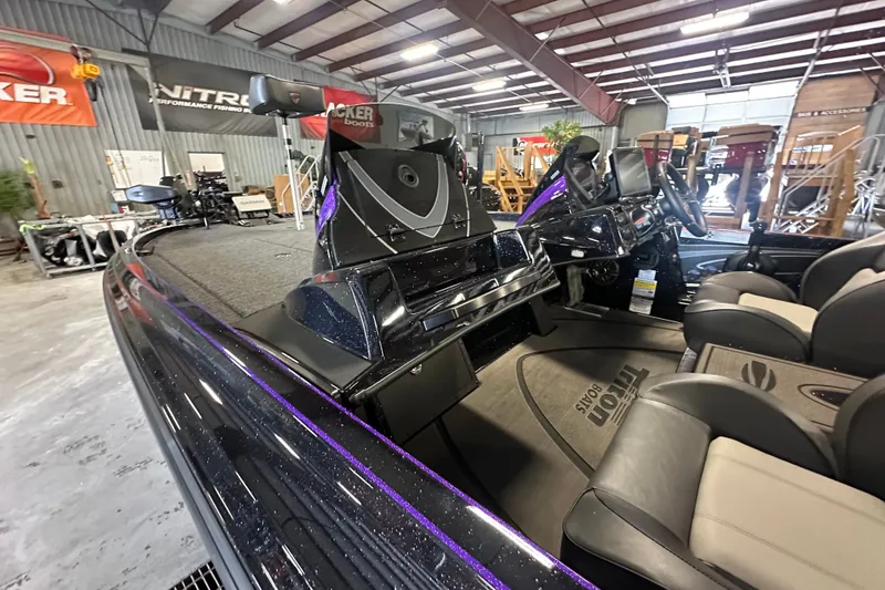 Slide: The Image of 2026 Triton 20XP Patriot boat interior in showroom, featuring sleek design and comfortable seating. - 19