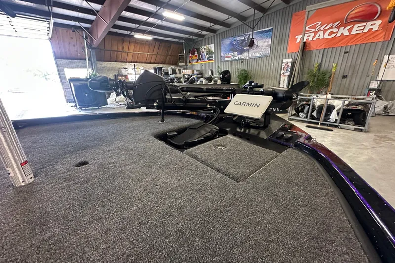Slide: The Image of 2026 Triton 20XP Patriot boat with Garmin equipment in a showroom. - 24