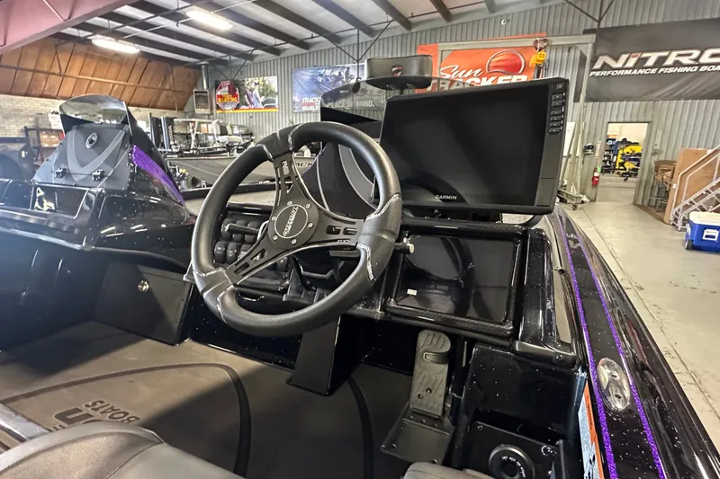 Slide: The Image of Interior of 2026 Triton 20XP Patriot boat with steering wheel and Garmin display. - 27