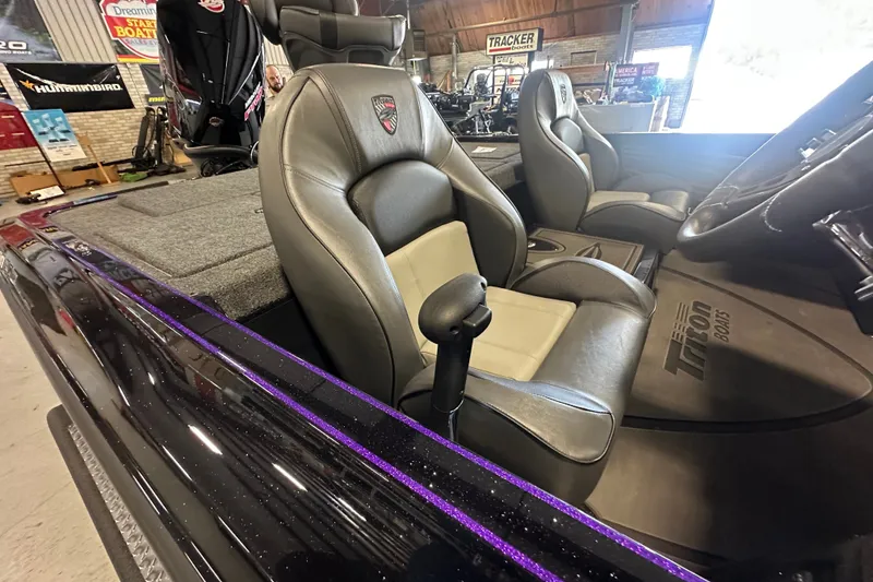 Slide: The Image of 2026 Triton 20XP Patriot boat interior with leather seats and steering wheel. - 26