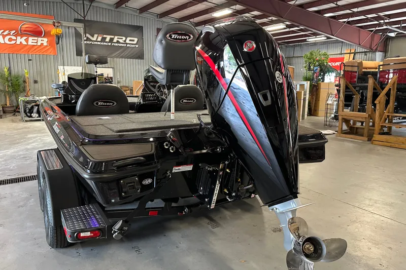Slide: The Image of 2026 Triton 20XP Patriot boat in showroom, featuring sleek design and powerful outboard motor. - 16