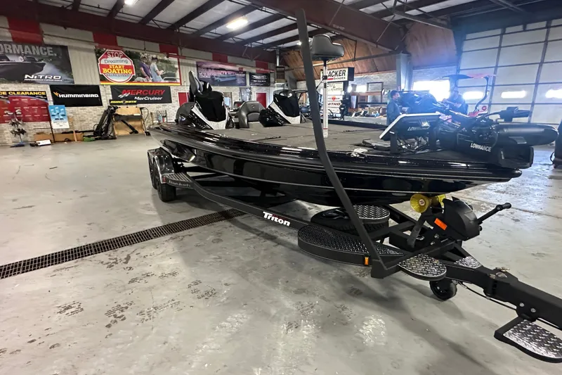 Slide: The Image of 2025 Triton 21XP Patriot boat in showroom, featuring sleek design and advanced equipment. - 6
