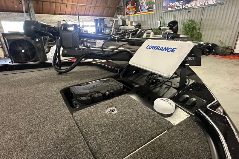 Slide: The Image of 2025 Triton 21XP Patriot boat with Lowrance electronics in a garage setting. - 7