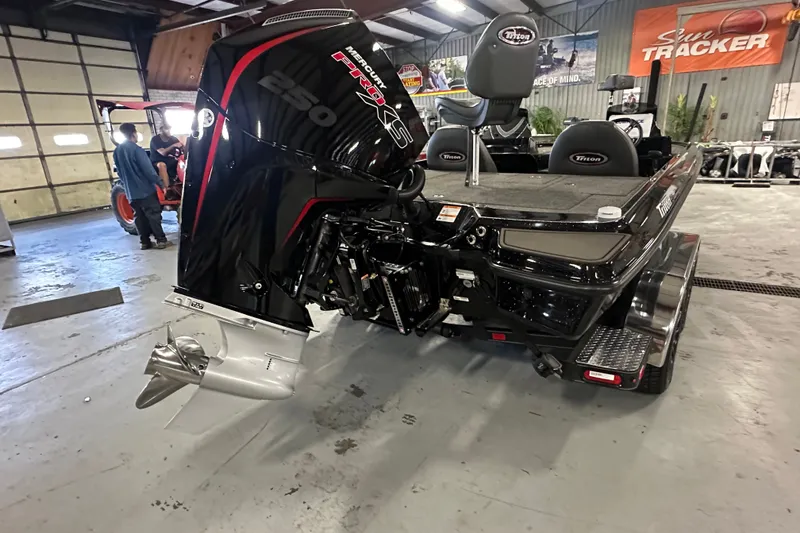 Slide: The Image of 2025 Triton 21XP Patriot boat with Mercury Pro XS 250 engine in a showroom. - 14
