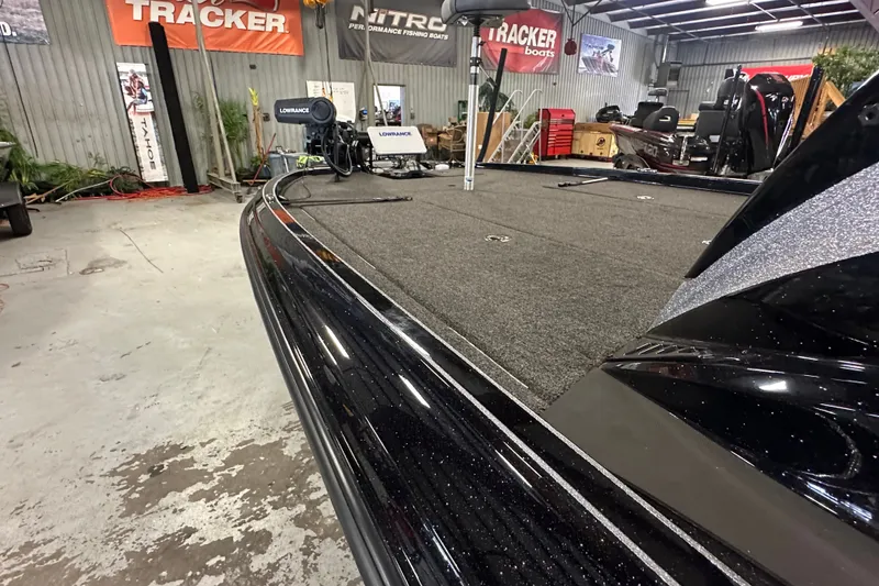 Slide: The Image of 2025 Triton 21XP Patriot boat in showroom, featuring sleek design and advanced equipment. - 18