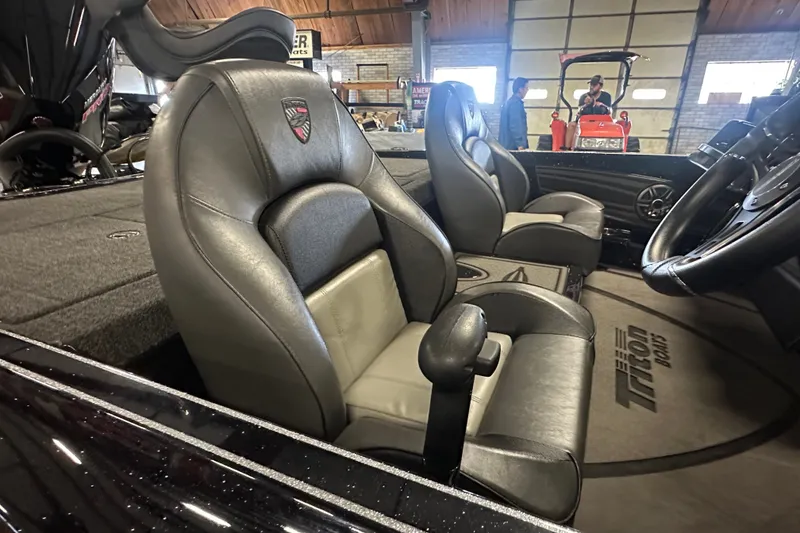 Slide: The Image of Interior of 2025 Triton 21XP Patriot boat with leather seats and steering wheel. - 10