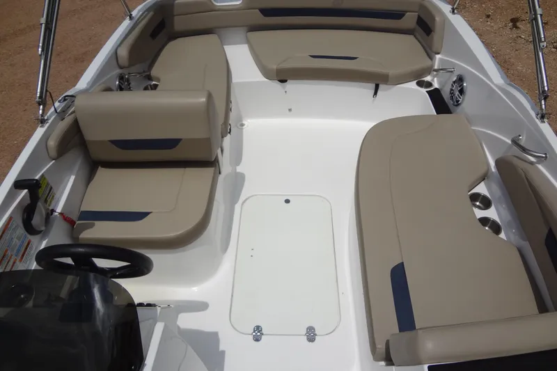 Slide: The Image of 2022 Hurricane SunDeck Sport 185 OB boat interior with beige seating and steering wheel. - 12