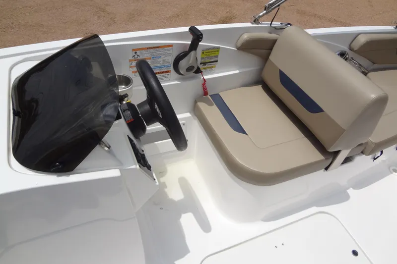 Slide: The Image of 2022 Hurricane SunDeck Sport 185 OB boat interior with steering wheel and seating. - 13
