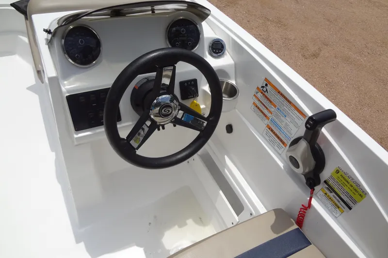 Slide: The Image of 2022 Hurricane SunDeck Sport 185 OB boat dashboard with steering wheel and controls. - 15