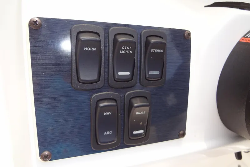 Slide: The Image of Control panel of 2022 Hurricane SunDeck Sport 185 OB boat with labeled switches. - 18