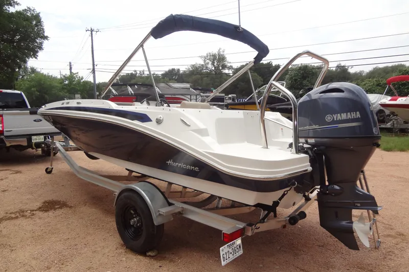 Slide: The Image of 2022 Hurricane SunDeck Sport 185 OB boat with Yamaha outboard motor on trailer. - 2