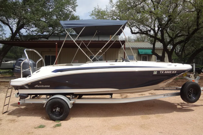 Slide: The Image of 2022 Hurricane SunDeck Sport 185 OB boat on trailer, parked outdoors. - 25