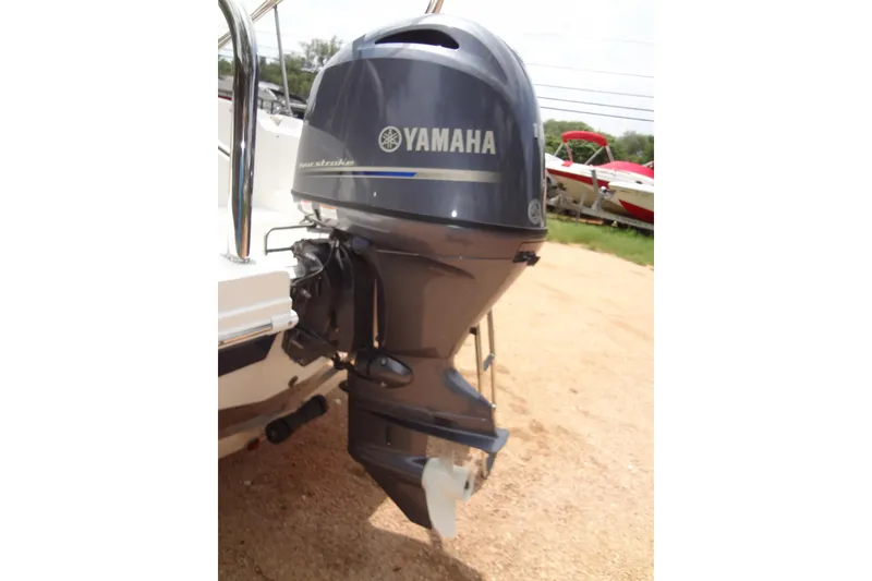 Slide: The Image of Outboard motor on 2022 Hurricane SunDeck Sport 185 OB boat, parked on gravel. - 31